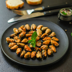 mussels in oil and spices (appetizer mollusks, pickled seafood, healthy food) menu concept. food background. copy space. Top view