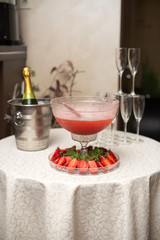 A pyramid of glasses. pink champagne with fruits.