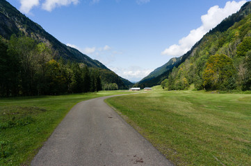 E5 transalp hiking path from oberstdorf to the kemptner hut at spielmannsau with grenn meadows and snowy mountains