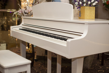 White piano and chair. white piano in the hall .Piano conner for relax and playing music.