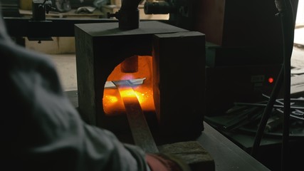 Forge workshop. Smithy manual production. Gas furnace for heating metal. Modern melting stove for...