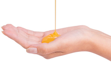 Yellow shampoo pouring on a female hand - obrazy, fototapety, plakaty