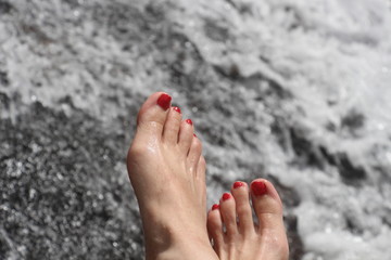 Woman's feet and water
