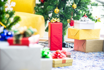 Christmas and New Year holiday concept. Closeup blur Christmas tree decoration with ribbons balls ornaments and gift boxes