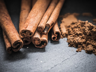 Cinnamon sticks and cinnamon powder on wood food photography