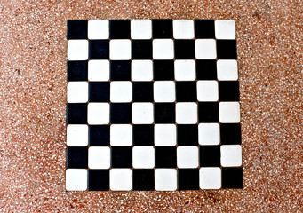 The stone table has a white and black checkerboard.