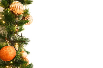 Golden orange bauble ball decorated on green Christmas tree branch with orange lights on white background, have copy space for put text - Powered by Adobe