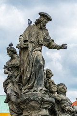 Fototapeta na wymiar Statue of St. Ivo at the Charles bridge, Prague, Czech, The statue depicts the patron saint of lawyers who are accompanied by Justice.