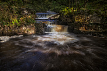 The base of Horseshoe falls, Sgwd y Bedol, at Sgwd Ddwli on the river Neath, near Pontneddfechan in South Wales, UK.