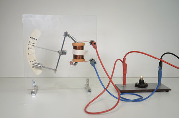 Pointer instrument demonstration; a coil activates the pointer mechanism when a current flows; (indicated by small lamp)