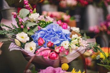 Colorful bright bouquets red, pink, blue, green, yellow colour from flowers of roses, chrysanthemums, eucalyptus, orchids