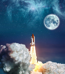 Cloudy launch of rocket Space Shuttle into colorful starry outer space and the full moon. "The elements of this image furnished by NASA" © Bernadett