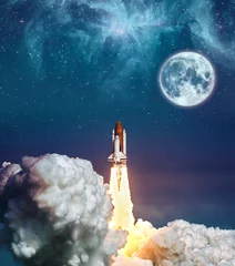 Plexiglas foto achterwand Cloudy launch of rocket Space Shuttle into colorful starry outer space and the full moon. "The elements of this image furnished by NASA" © Bernadett