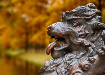 Old bronze dragon in the autumn park