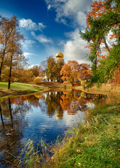 The colors of autumn. Beautiful view reflection on an old church