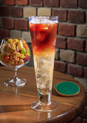 Coffee with ice, energy drink in a tall glass on a wooden background. Energy drink. Coffee house.