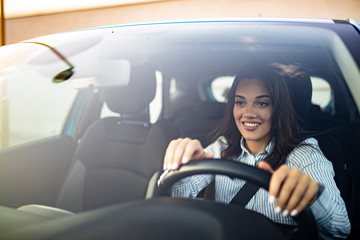 Beautiful Smiling woman driving car, attractive girl sitting in automobile, outdoors summer...