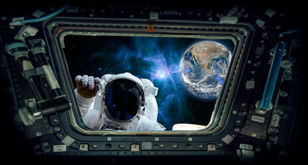 astronaut knocking and the earth "Elements of this image furnished by NASA" © Bernadett