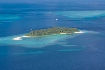 Fototapeta na wymiar Aerial view of Maldives atolls is the world top beauty. Maldives tourism. Amazing aerial of the beautiful atolls of the Maldives.