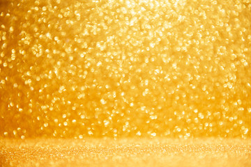 Gold glittering christmas lights. Blurred abstract background.