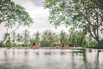 Infinity pool with a view on palm trees, Ubud, Bali