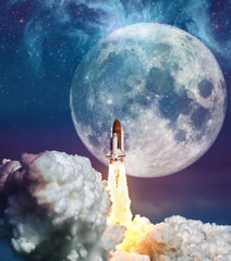 Cloudy launch of rocket Space Shuttle into colorful starry outer space and the full moon. 