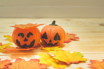 Halloween pumpkins with painted faces on a wooden table. Halloween background. Space for text. copy space.