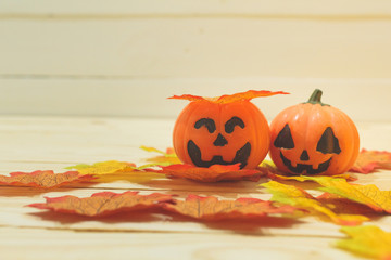 Halloween pumpkins with painted faces on a wooden table. Halloween background. Space for text. copy space. Halloween concept