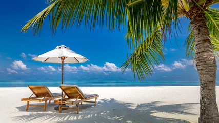 Luxury beach resort, beach loungers near the sea with white sand over sea Topical island...