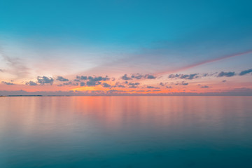 Naklejka na ściany i meble Inspirational calm sea with sunset sky. Meditation ocean and sky background. Colorful horizon over the water