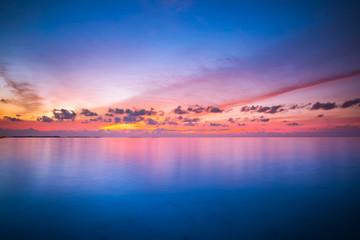 Fototapeta na wymiar Dreamy ocean or sea with colorful sky and water reflection. Heaven concept, boost up color process