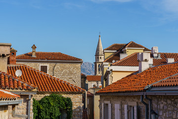 Tiled roofs of ancient buildings, windows and balconies.