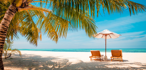 Obraz na płótnie Canvas Beautiful Maldives island beach landscape. Luxury resort with chairs and umbrella for summer vacation and holiday background. Exotic tropical beach concept