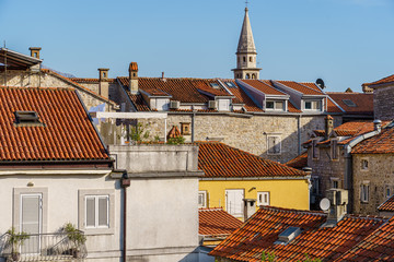 Tiled roofs of ancient buildings, windows and balconies.