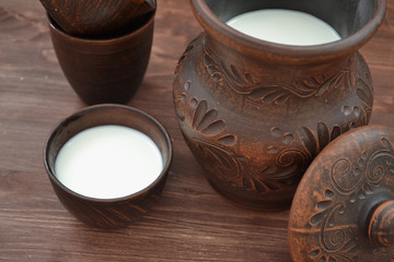 Organic milk in pottery on rustic wooden table