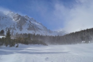 Fototapeta na wymiar Popradske pleso in winter. Sunny day, white clouds, beautiful mountains. High Tatras, Slovakia.