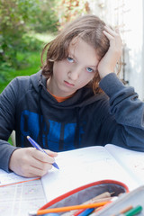 Boy Doing Homework Outdoors