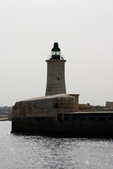 Fototapeta na wymiar sea lighthouse on a background of blue sea