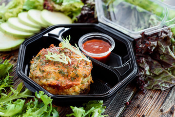 potato pancakes with red sauce in eco container. Take with you. Food delivery. Useful sports nutrition. Detox