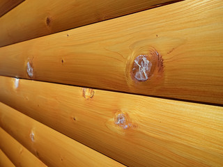 Patched holes from in a wood surface. Fixed wood house. Patch wood scars on a wooden house.