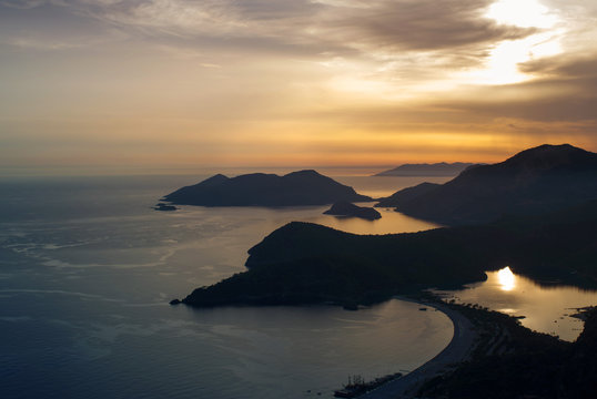 Seascape with mountain silhouettes at sunset.  Turkish Oludeniz Beach, aerial view from the mountain