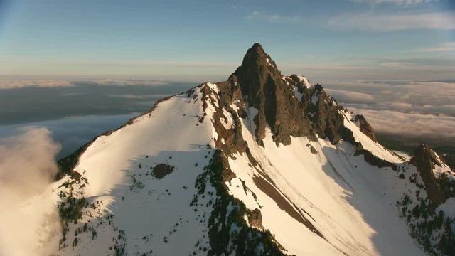 Cascade Mountains, Oregon circa-2019.  Aerial view of Three Fingered Jack.  Shot from helicopter with Cineflex gimbal and RED 8K camera.