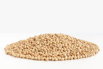 A lot of soybeans pile isolated on white background with copy space for text. Concept food for healthy. Soybean is a leguminous plant native to Asia, widely cultivated for its edible seeds.