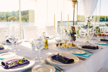 Banquet table with wedding and festive serving in white blue and purple colors