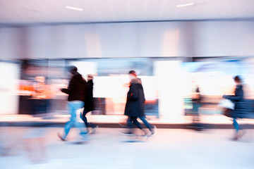 Large group of real people walking indoors, shopping spree