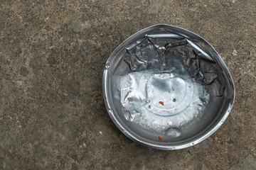 an old used stainless steel dog's food bowl
