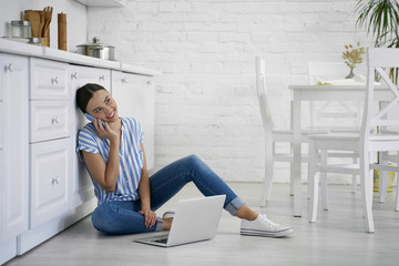 Enjoying phone talk at home in the kitchen stock photo