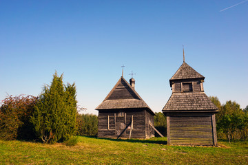 Fototapeta na wymiar Wooden catholic church in the ancient village of Strochitsa Ozertso, Minsk region, Belarus.