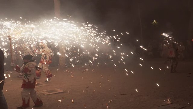 Traditional correfoc performance. In the correfoc, a group of individuals will dress as devils or Diables and light fireworks - fixed on devil's pitchforks or strung above the route