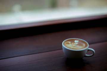 coffee latte art on wooden table in a cafe